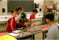 Professor with elementary students in Lab